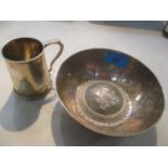 An Indian white metal christening mug, together with a bowl