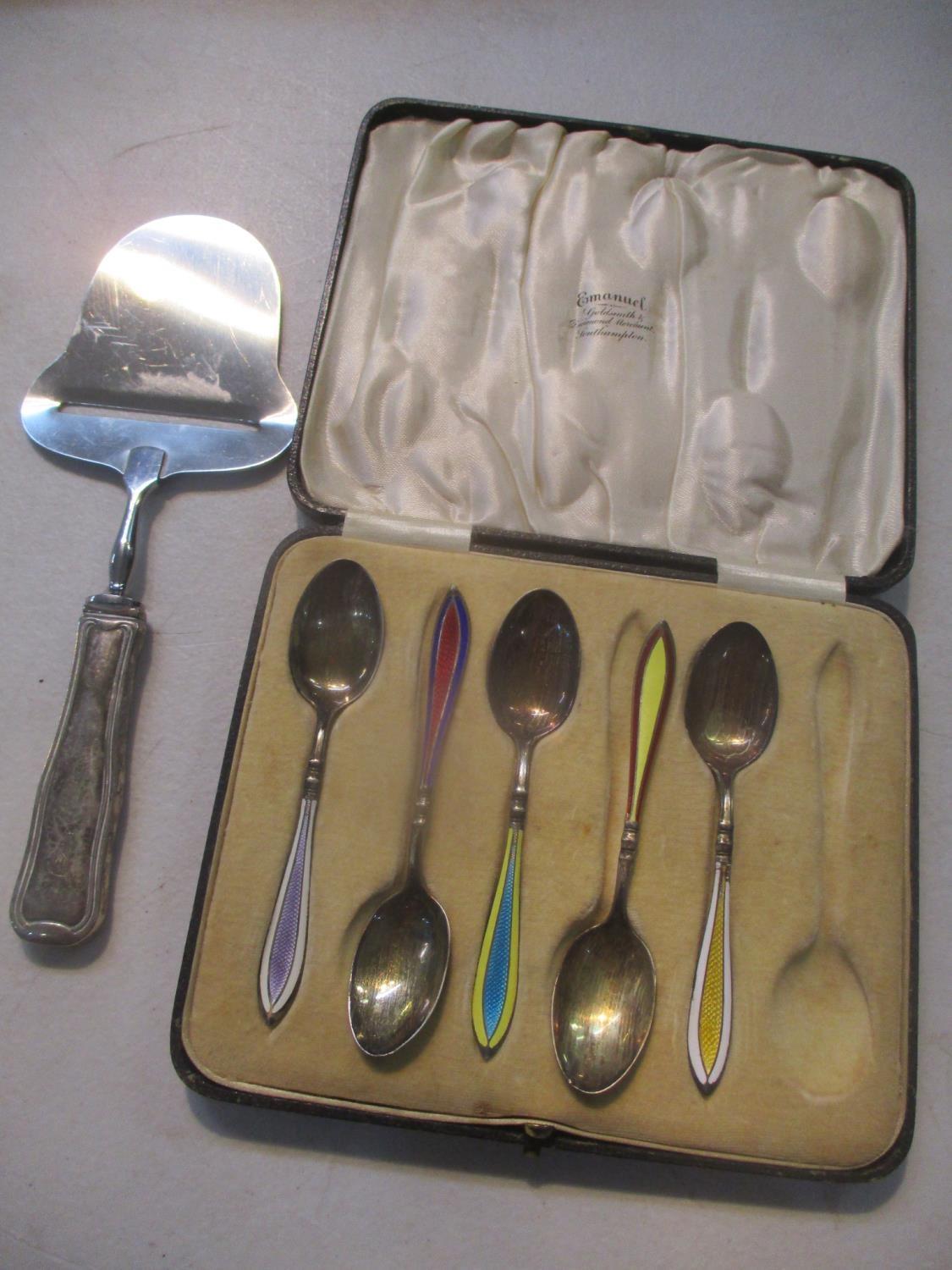 A Georg Jensen silver handled cheese plane, together with five silver teaspoons with enamelled