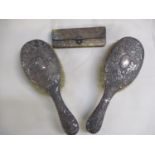 A pair of ornate silver backed hairbrushes and a silver and snakeskin purse