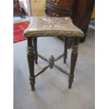 A 19th century small square shaped stool with crossbanded support, having a carved top