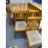 A mid 20th century oak extending table and six matching chairs