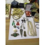 Early to mid 20th century costume jewellery to include a three string pearl necklace, earrings,