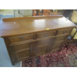 A reproduction oak sideboard having three drawers above three cupboard doors, 90h x 46cm w