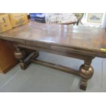 An early 20th century oak draw leaf dining table in the 17th century style