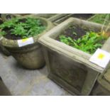 Two composition garden planters to include a square framed planter decorated with floral motifs,