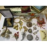 Mid 20th century costume jewellery to include brooches, a silver gilt example with coral coloured