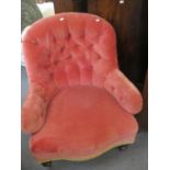 A Victorian button backed armchair in pink upholstery