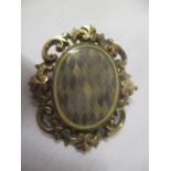 A yellow coloured metal Victorian mourning brooch set with women's hair, 25g combined