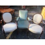 A late Victorian mahogany salon armchair, together with a pair of oval backed armchairs