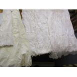 Four early 20th century ladies cotton, crotched and lace underskirts together with a cotton