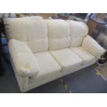 A modern cream three seater sofa