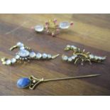 Two gilt metal brooches fashioned as scorpions set with moonstones, A/F, a yellow metal brooch set