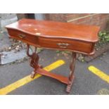 A reproduction mahogany serpentine fronted side table having single inset drawer and lyre shaped