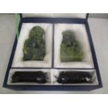 A pair of late 20th Century Chinese jade coloured Foo dogs, on stands boxed