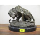 After A Barye - a modern bronze model of a lion and a snake, on a black marble base, 23cm h