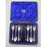 An early 20th century cased set of silver teaspoons and sugar tongs