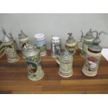 Nine German ceramic beer steins, the majority with cast metal hinged lids