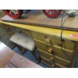 A modern pine dressing table with four graduated side drawers on bun feet, along with a dressing