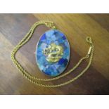 A Chinese pendant with opal style panel and yellow metal on a rope twist chain, stamped 9ct