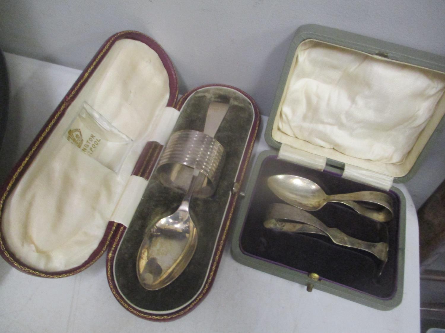 Two early 20th century silver cased christening sets, 102.95g