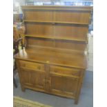An Ercol Golden Dawn elm dresser having a plate rack above two drawers and cupboards 160 1/2cm h x