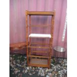 Furniture to include an American walnut six tier shelf, a two drawer hall table and a wrought metal,