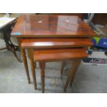 A nest of three yew wood tables Location: G
