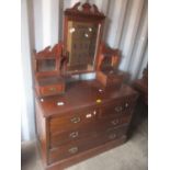 A late Victorian walnut dressing table having a swing mirror above drawers and standing on a