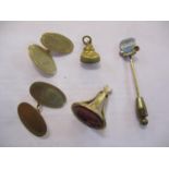 A pair of 9ct gold cufflinks, a 9ct gold charm of a Buddha, a silver gilt stick pin with two small