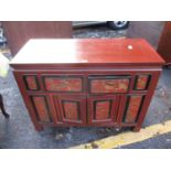 A 20th century Chinese red, gold and black cabinet with two drawers and two doors on carved feet