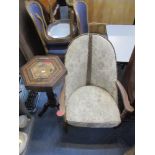 An early 20th century oak stud back low armchair, together with a marquetry inlaid octagonal