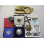 A Bakelite magnifying glass, a 1910-1935 silver commemorative coin, various badges and medals and