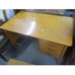 A mid 20th century light oak three drawer inset desk 77cm h x 114cm w