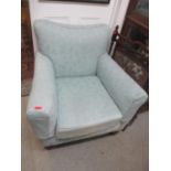 A Victorian upholstered armchair on turned tapered mahogany legs
