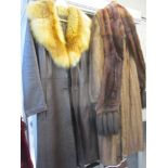 A retro ladies dark brown leather coat with red fox fur collar, together with a full length mid