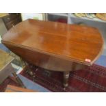 A 19th century oak drop leaf dining table and two additional mahogany leaves