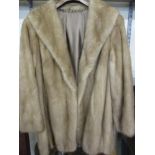 A vintage light brown mink hip length coat with brown satin lining with an embroidered name Yvonne