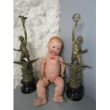 An Armand Marseille porcelain headed doll and a pair of late Victorian French spelter figures