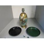 An Art Deco WMF Ikora diandries table lamp and two Art Deco enamelled coasters, one with geometric