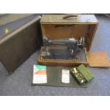 A 1946 Singer sewing machine and accessories, together with a travelling case, serial number