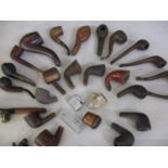 A collection of smoking pipes and lighters to include cased examples