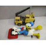 A Tonka die cast excavator truck, yellow colour, together with a Donald Duck decorative model,