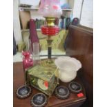 A Victorian oil lamp with ruby glass reservoir and pink glass shade A/F and another, together with a