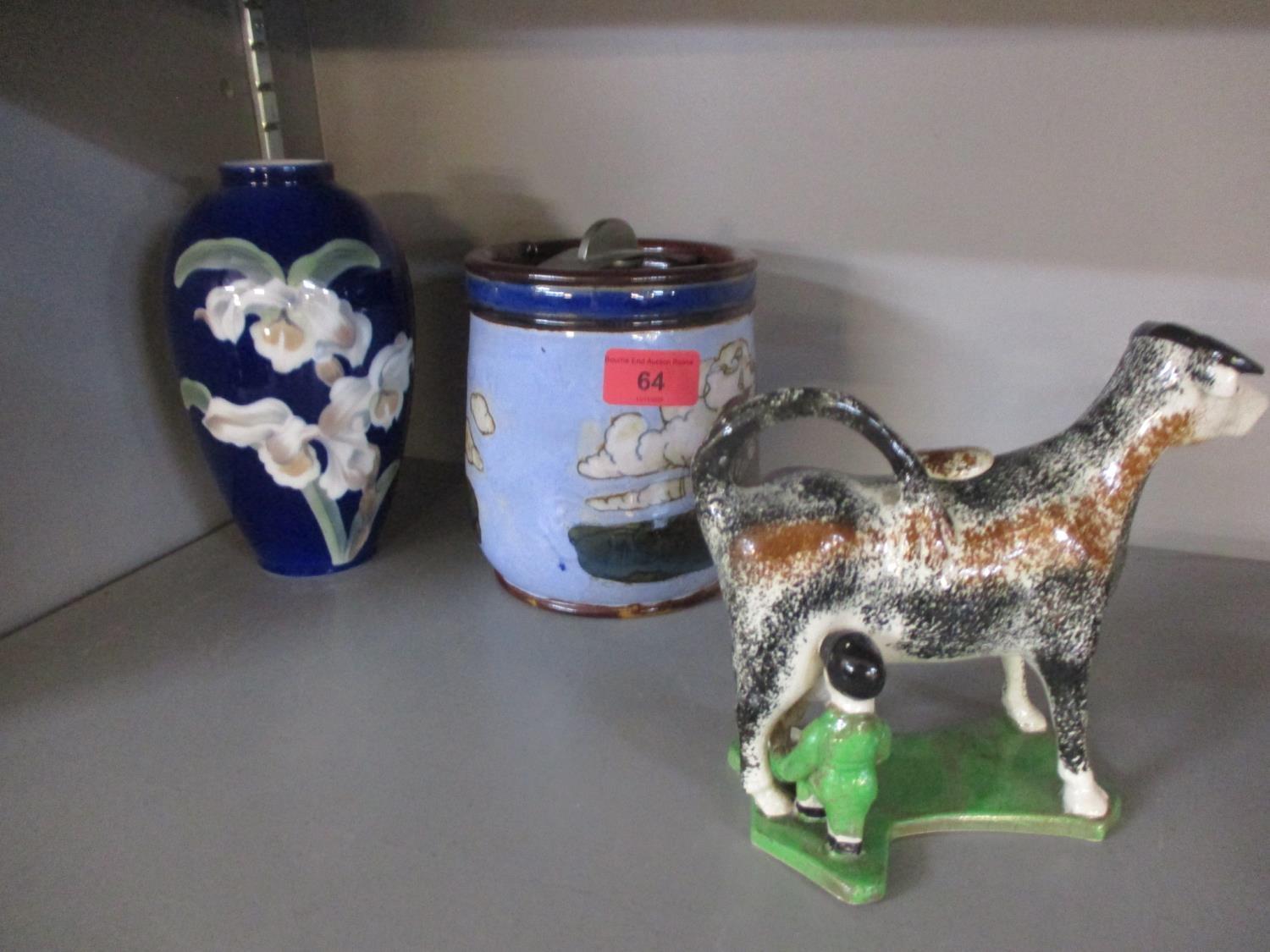 A Lambeth Doulton tobacco jar, a Royal Copenhagen vase, a creamer in the form of a cow and other