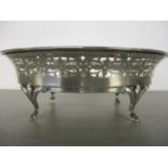 A silver oval dish with pierced sides on splayed feet, 18cm w, 133g