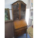 A Queen Anne style walnut veneered bureau bookcase, two doors above three drawers, 204cm h x 76cm w