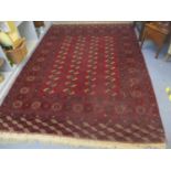 A red ground wool Bokhara rug 303cm x 202cm