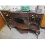 An Edwardian mahogany side cabinet with two short drawers and a shelf, on carved cabriole legs, 103h