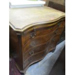 A reproduction serpentine fronted gentleman's dressing chest with brushing slide, four graduated