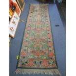 A hand woven terracotta ground runner with tasselled ends 298 x 91cm